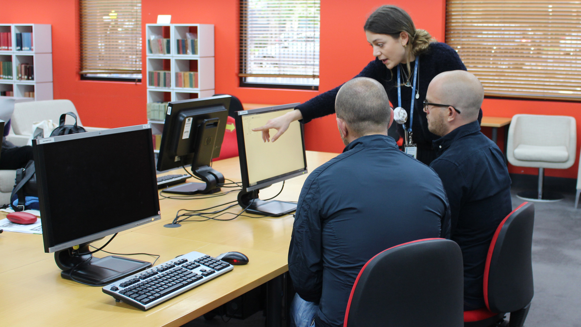Reading Room image A woman assisting researches with the computers in the reading room